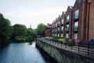 View: t11434 View from Ball Street Bridge of Kelham Weir and (right) Miba Tyzack Ltd., (formerly W.A. Tyzack and Sons Co. Ltd.), Horsemans Works, Green Lane and Brooklyn Works Apartments (on the site of the former Brooklyn Works)