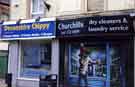 View: t11573 Shops on Division Street showing No. 105 Devonshire Chippy and No. 107 Churchills, drycleaners and laundry service