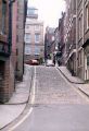 View: t11838 Photograph taken from part way down New Street. The red car at the top is turning into Bank Street.