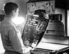 Negative of a front page being inspected in the process department, Sheffield Newspapers Ltd., York Street