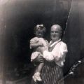 T. Cooke, fish and game salesman, holding child, No. 229 London Road