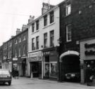 View: u11679 Shops on Norfolk Row showing (r. to l.) No. 2 Georgian Goldsmiths Ltd., St. Maries book shop, GT Sports, Golf Scene and Mark Jenkinson and Son, estate agents