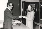 View: u11743 Robert Atkins, City Librarian, hands over the first ticket for the new Plessey book issuing system, Central Lending Library, Central Library, Surrey Street