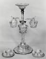 A miniature sweet-meat stand with three branches and three baskets. Oval shaped top cup. Beautifully facetted. 12ins. high. Waterford Glass