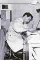 Don Cantrell, senior architect, Architects Department, Sheffield City Council seated at his desk in traditional drawing office smock